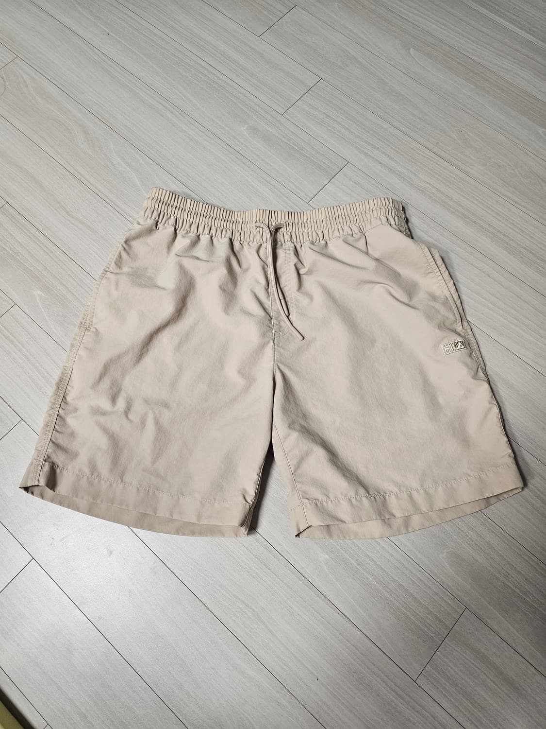 FILA 베이지 반바지 (남녀공용) 상품이미지1