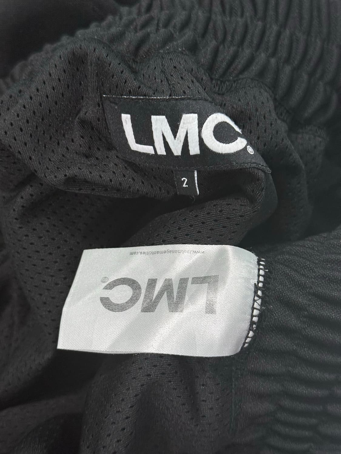 LMC 엘엠씨 사이드 라인 스냅 단추 로고 레터링 트랙 팬츠 블랙 밴딩 상품이미지9
