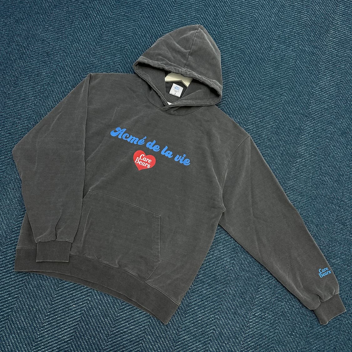 [1] 아크메드라비 X 케어베어스 피그먼트 후드티 상품이미지1