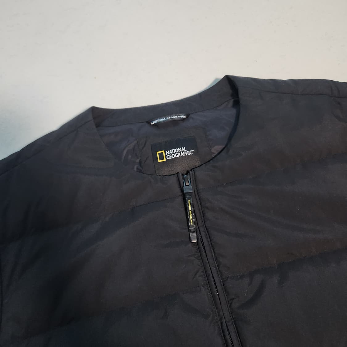 내셔널지오그래픽 와펜 블랙 경량패딩 상품이미지1
