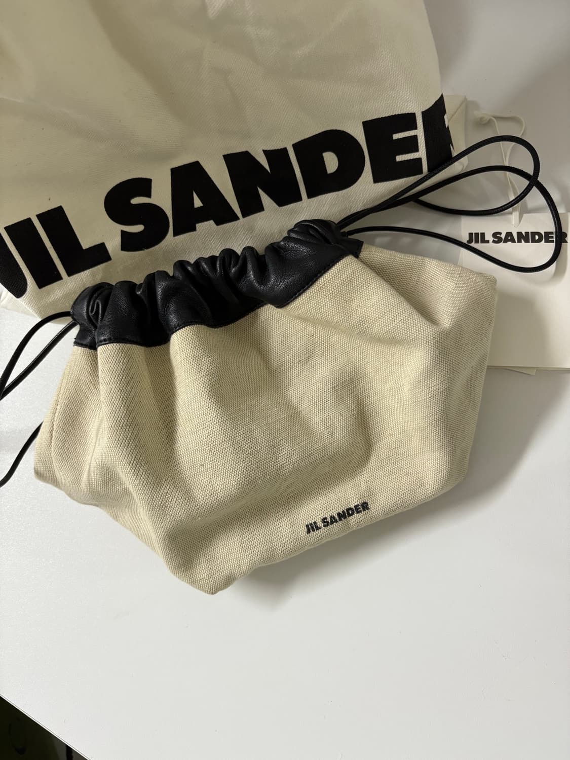 질샌더 드로우 스트링 캔버스 크로스바디 백 상품이미지1