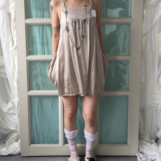 Glossy unbalanced point sleeveless onepi