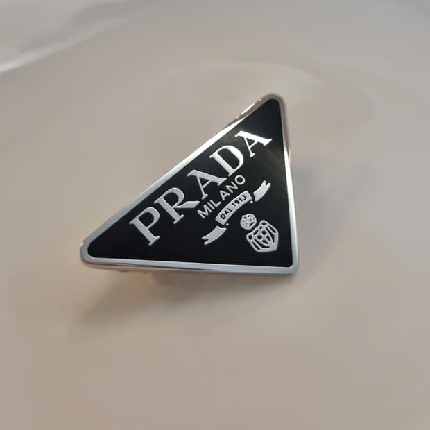 프라다 업사이클링 삼각로고 자동핀 블랙