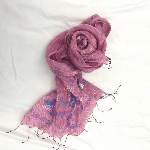 A pink embroidered fringed gauze scarf