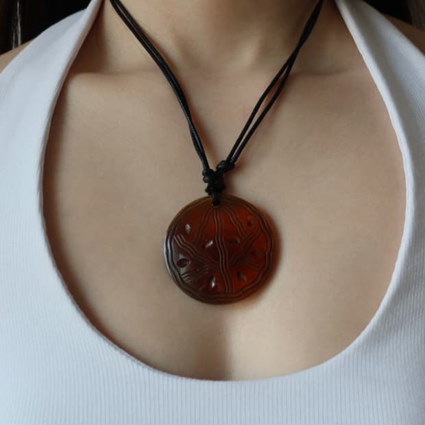 red carved necklace