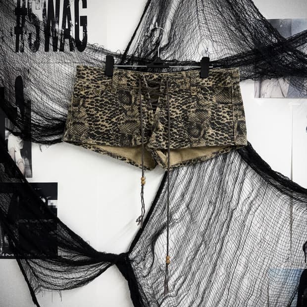 Snake pattern eyelet shorts