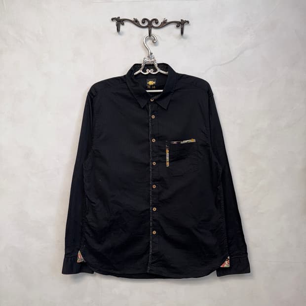 Black oriental detail over loose shirt