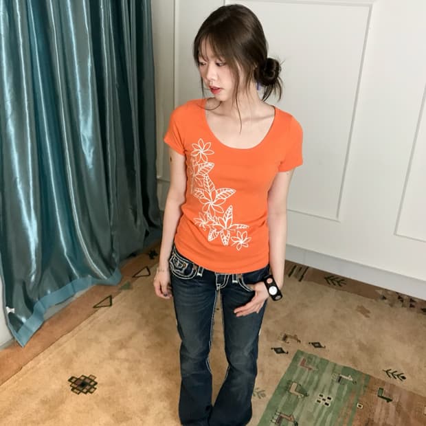 비비드한 오렌지 그래픽 티셔츠와 트루릴리젼 부츠컷 데님에 Y2K 무드🧡