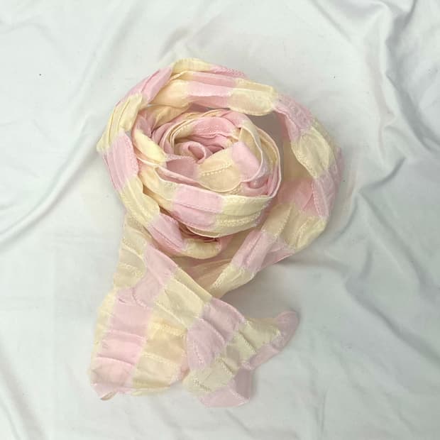 A pink and cream crinkled gauze scarf