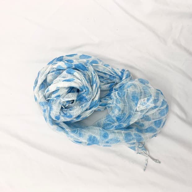 A light blue sheer scarf