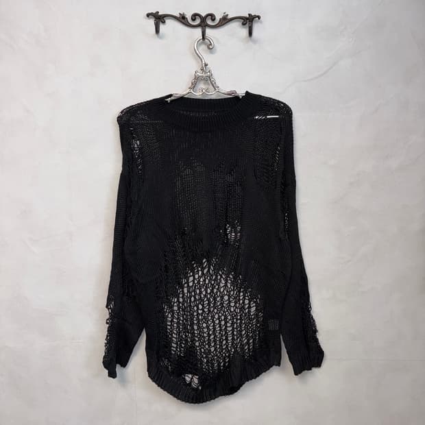 Black grunge damage over loose knit