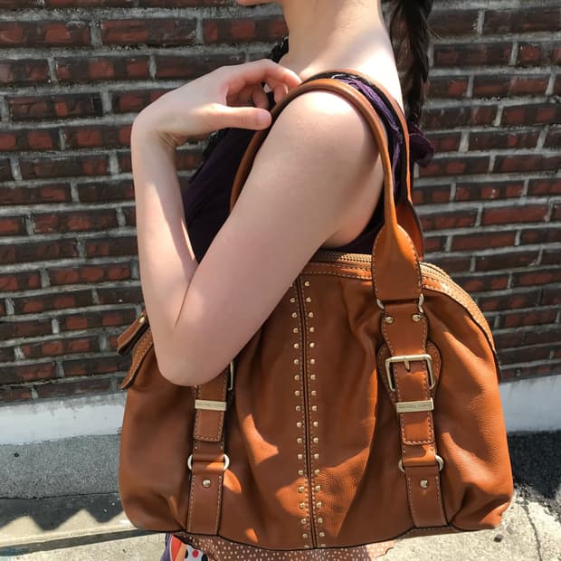 Michael Kore brown buckled leather bag