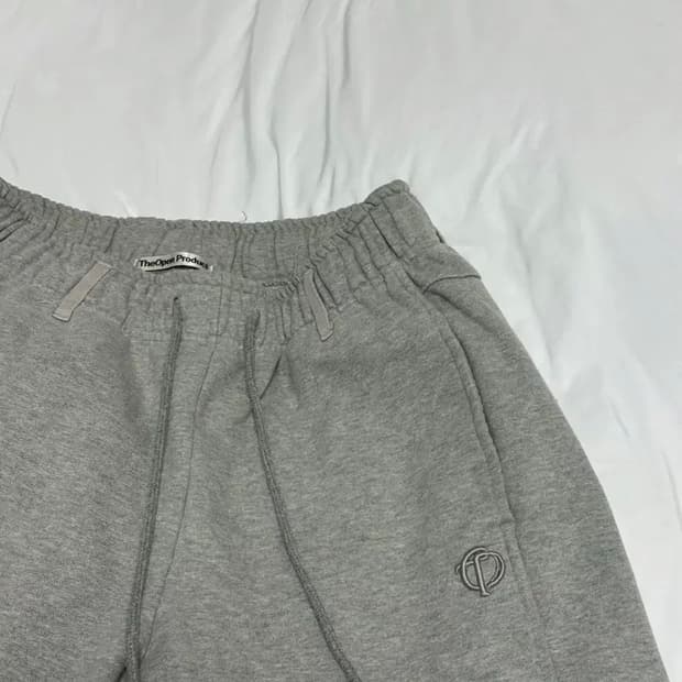 더오픈프로덕트 헤리티지 로고 라운딩 트랙팬츠