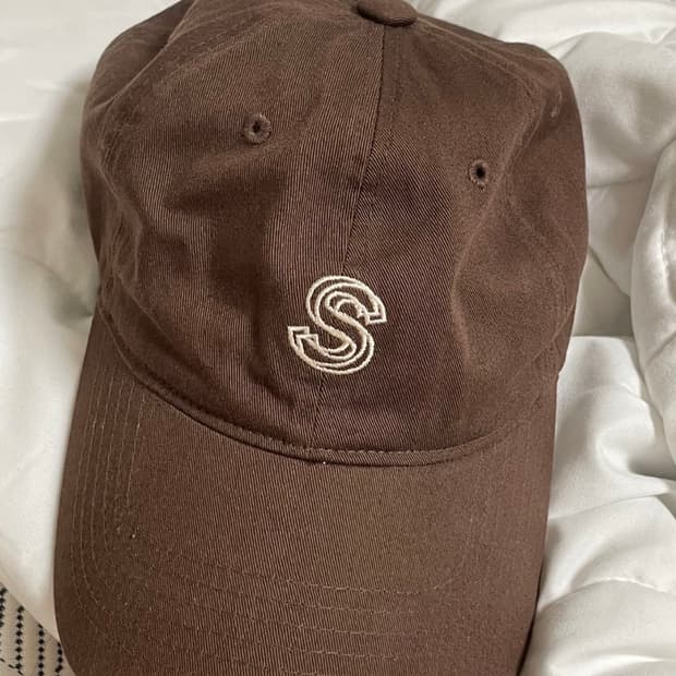 S logo brown cap