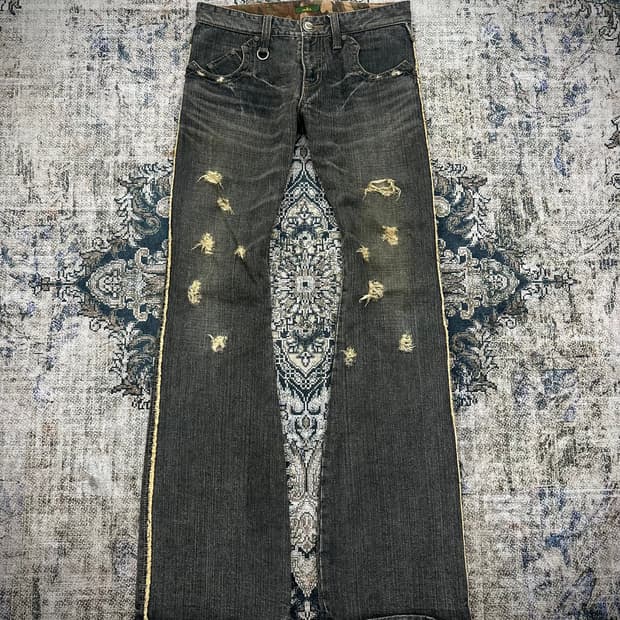 Obelisk bullet damaged flared jeans
