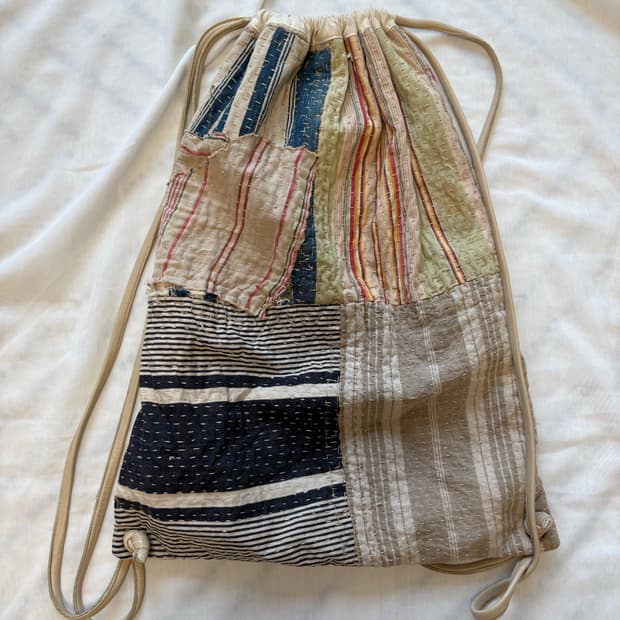 By walid 패치워크 드로스트링 백 