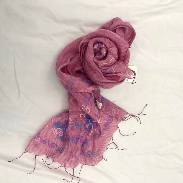 A pink embroidered fringed gauze scarf