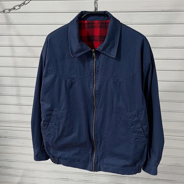 Wears western bomber jacket