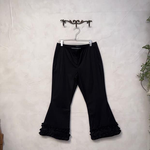 Black ruffle detail bootscut pants